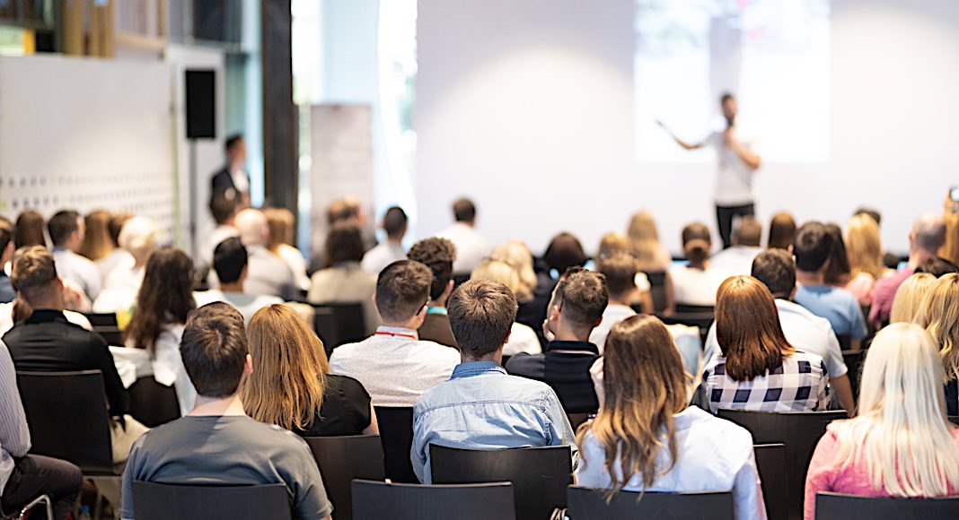 Speaker,Giving,A,Talk,In,Conference,Hall,At,Business,Event. Speaker,Giving,A,Talk,In,Conference,Hall,At,Business,Event.